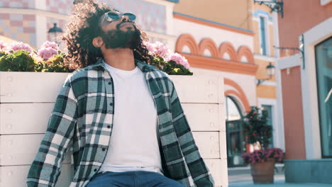 stylish man sitting outdoors