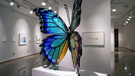 colorful glass butterfly sculpture in a museum