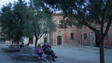 people relaxing in a tranquil italian town square