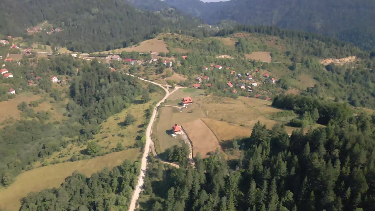 Aerial shots of zaovine lake tara national serbia complex in national Serbia.Aerial View of Green Landscape and Houses in Scenic Mountain's Resort on Sunny Day, Drone Shot.