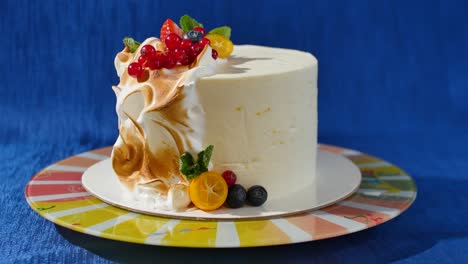 elegant white cake with fruit and meringue