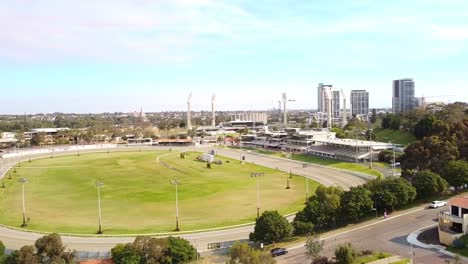 aerial view of a horse racing track in a city