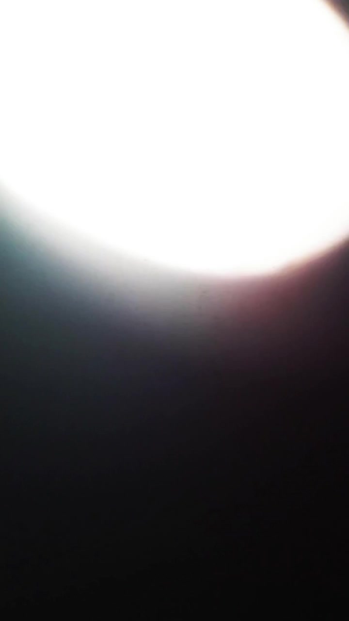 Bright Light Flare Appearing and Fading on Black Background