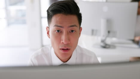 asian man, thinking and working on computer