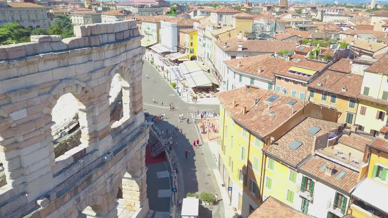 Aerial panoramic view of Arena di Verona, Italy. The drone flies near the wall of the arena with arches. A view of the Arena and the city opens. 4k vieo.