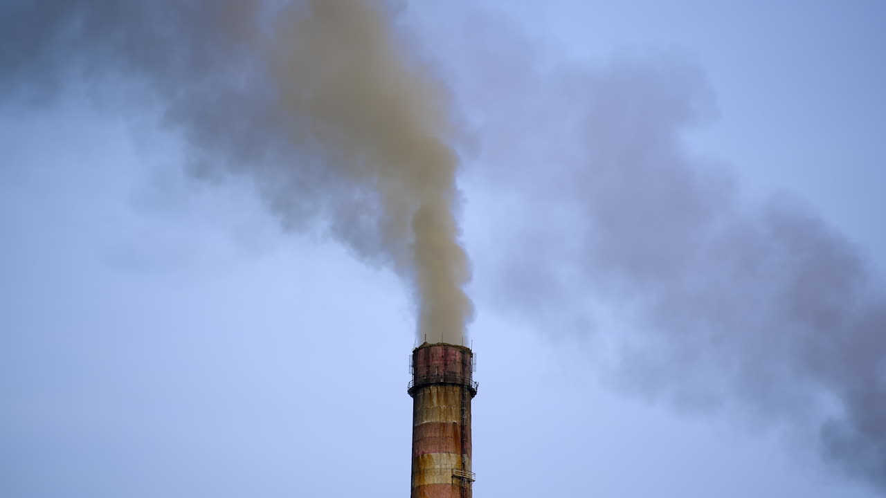 Smokestack in the air from industry. Chemical fumes fron industrial pipe filling the sky in the evening. Harmful emissions in the atmosphere. Ecology in danger.