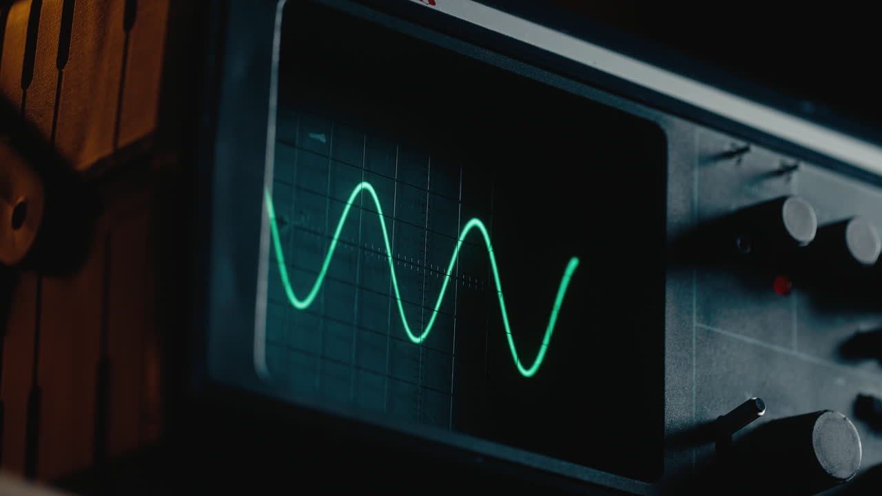 Closeup on the oscilloscope screen waves appears
