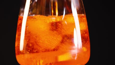 close-up of aperol spritz with ice cubes