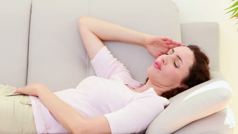 sad brunette lying on the couch