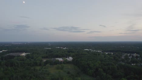 An-aerial-shot-of-an-empty-dry-cracked-swamp-reclamation-soil,-land-plot-for-housing-construction-green-meadow,-beautiful-views-and-beautiful-blue-sky-with-fresh-air-Land-for-sales-landscape-concept