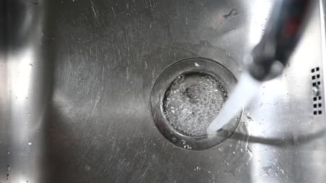 water running into kitchen sink drain