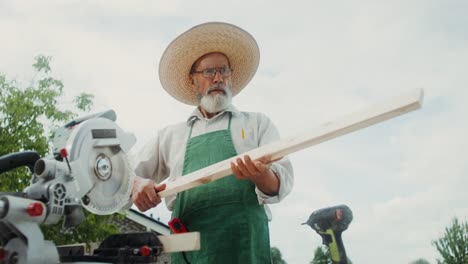 senior man woodworking outdoors