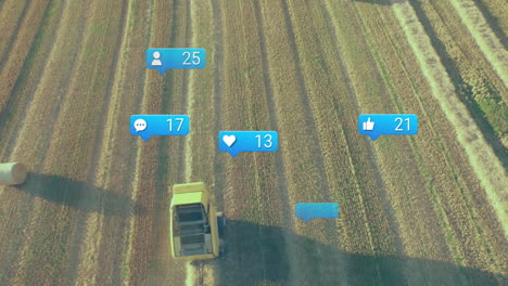 flat design yellow combine harvester driving over harvested field rows, social media icons floating
