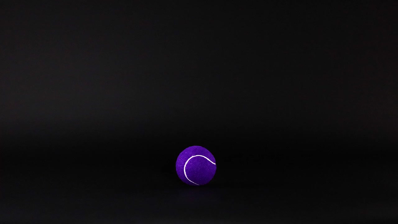 A purple tennis ball moves across frames