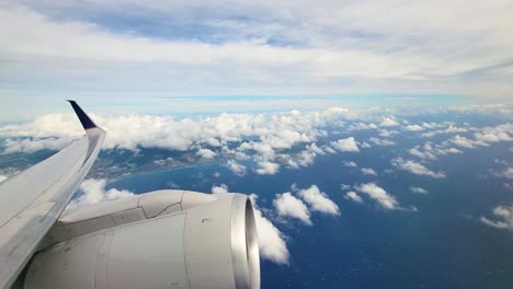 aircraft wing and engine viewed from the window of a flying airplane