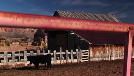 Panning-Up-Through-Foreground-Of-Fence-Of-Rural-Utah-Ranch-House-And-Farm