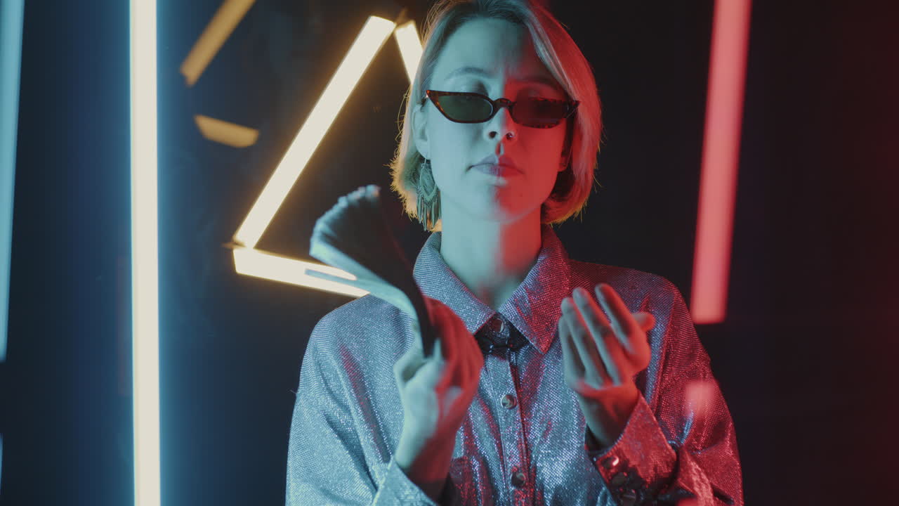 Woman Holding Money in Neon Light