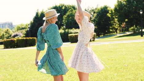 two women friends enjoying a summer day in a park