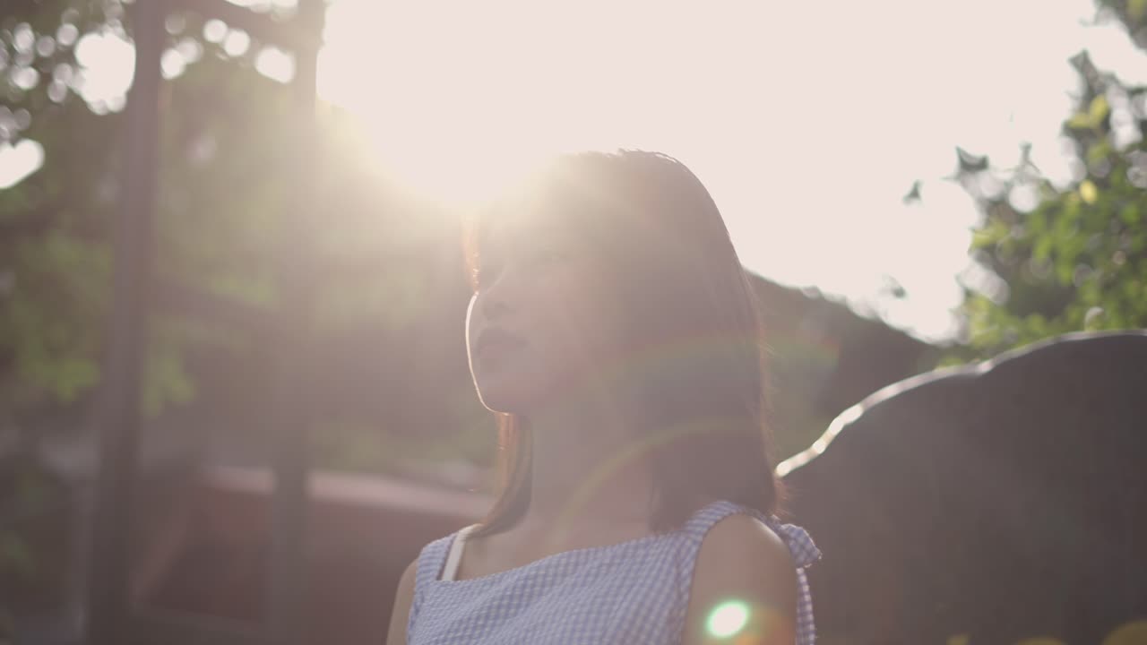 Thoughtful girl outdoors in sunlight