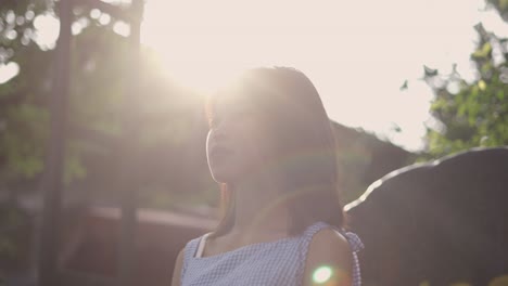 thoughtful girl outdoors in sunlight
