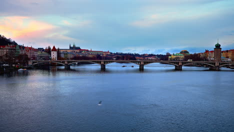 jirásek bridge over vltava river in prague with city skyline at dusk