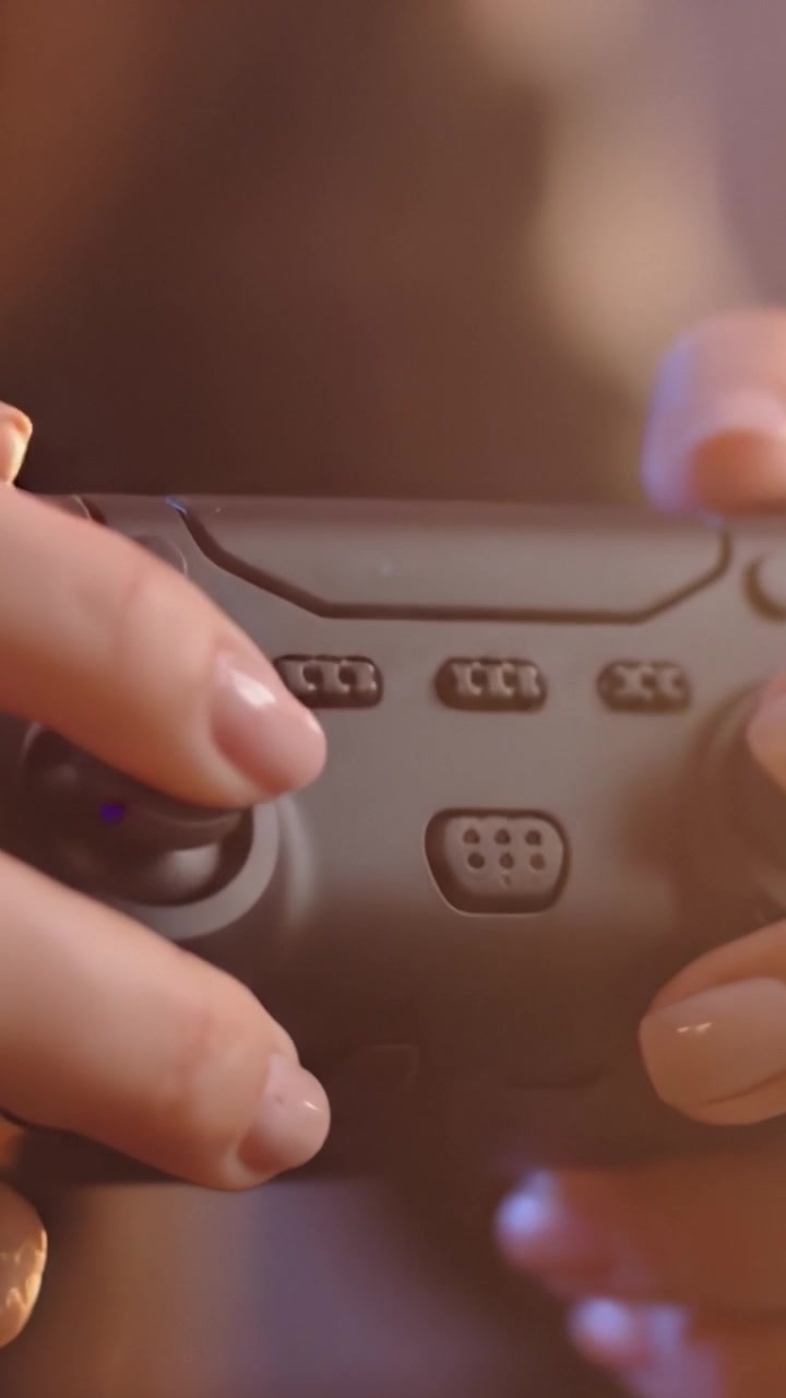 Close-Up of a Gamer's Hands on a Modern Video Game Controller: A Dive into Interactive Entertainment and Digital Play Experiences