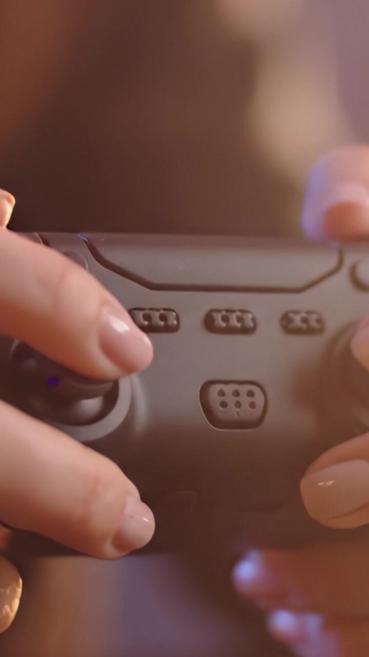 Close-Up of a Gamer's Hands on a Modern Video Game Controller: A Dive into Interactive Entertainment and Digital Play Experiences