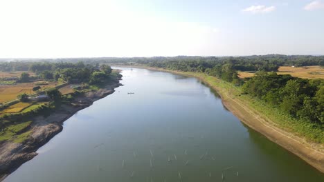 aerial view of the breathtaking surma river surrounded by tree filled farmland