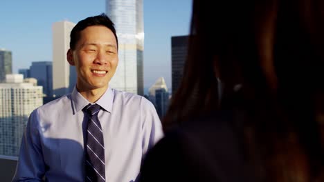 hispanic female talking strategy with asian male colleague