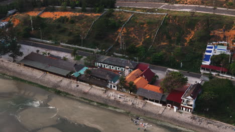 Drone-follow-traffic-on-beach-side-boulevard-road-in-Mui-Ne-resort-touristic-town-in-Vietnam-Asia