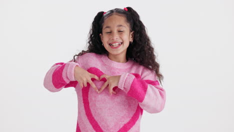 girl making heart shape with hands