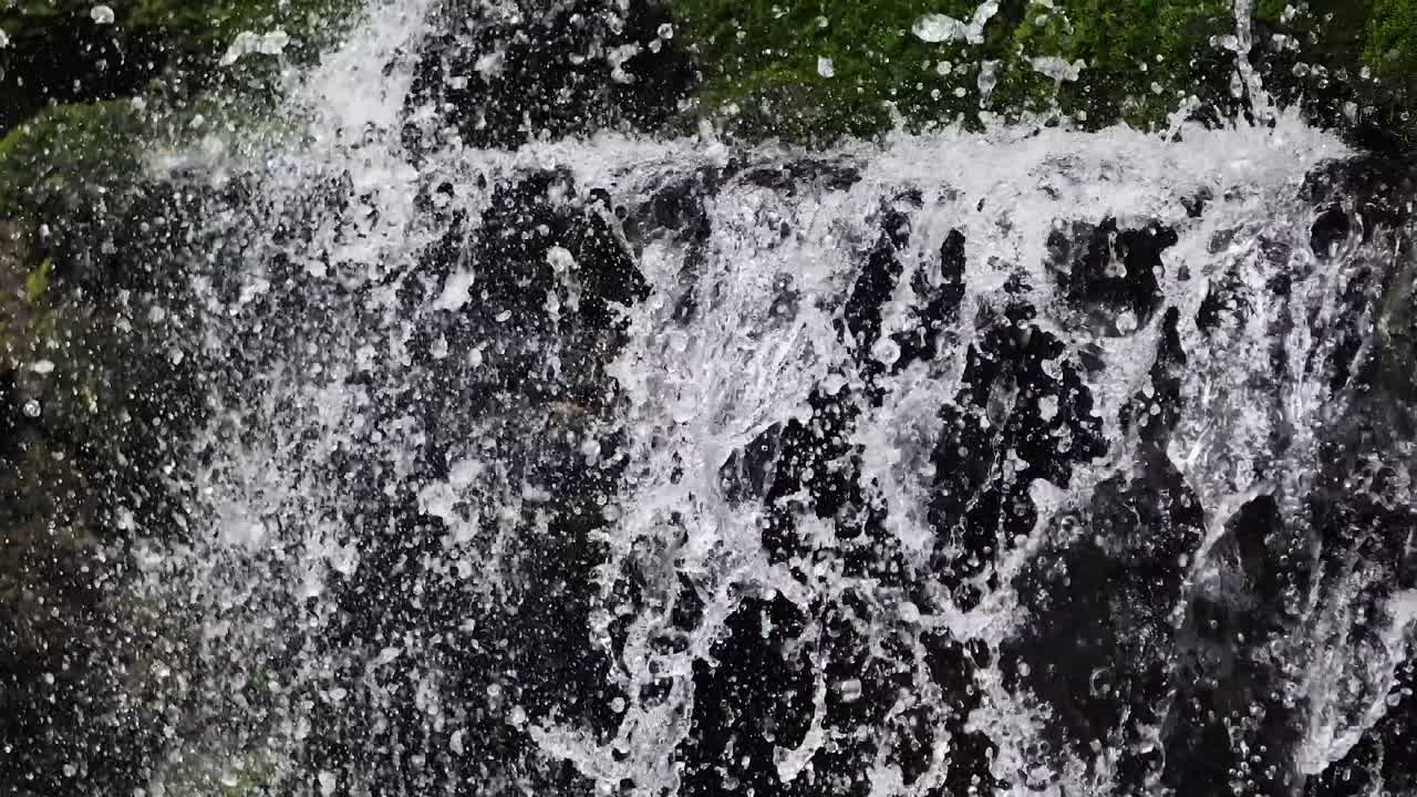 Water cascading over rocks in lush greenery
