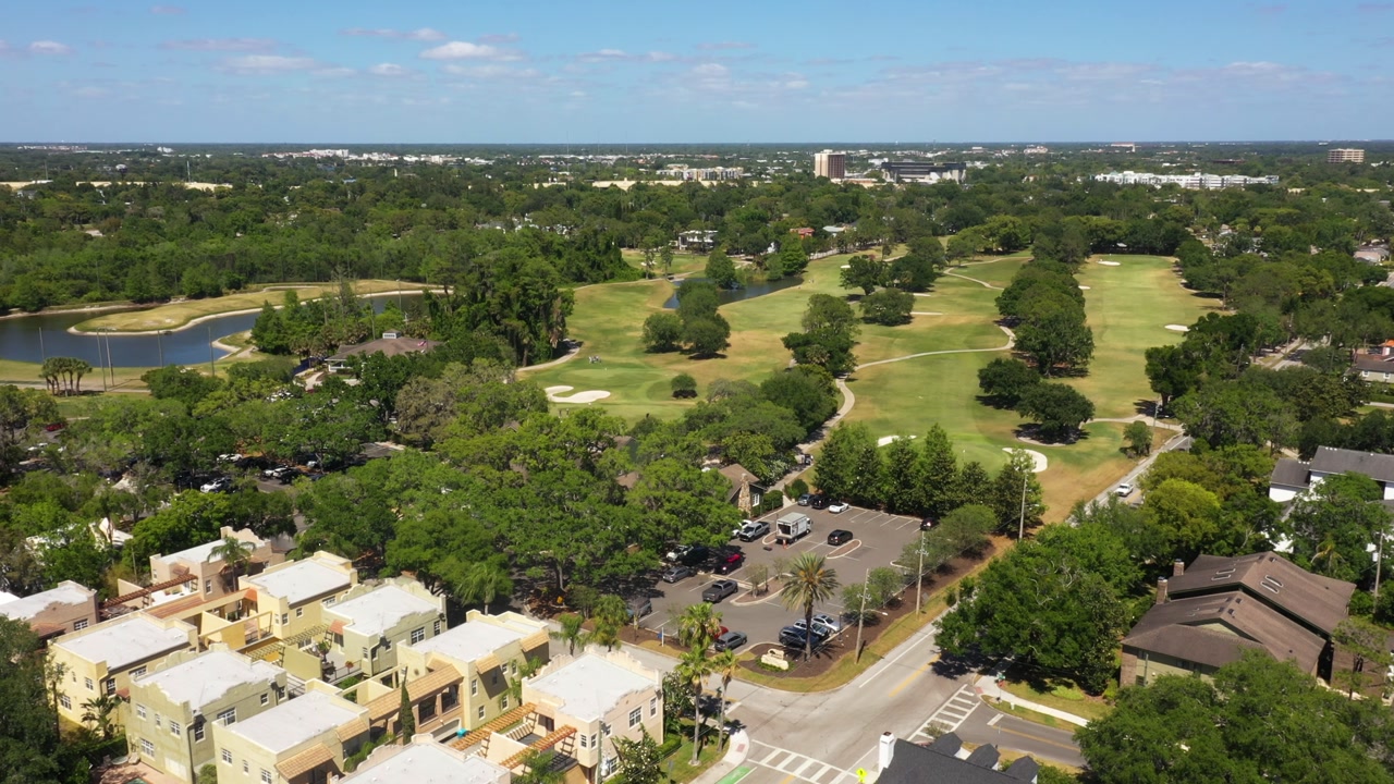 A sweeping aerial shot showcases the classic layout of Dubsdread Golf Course surrounded by tree-lined neighborhoods in Central Florida.