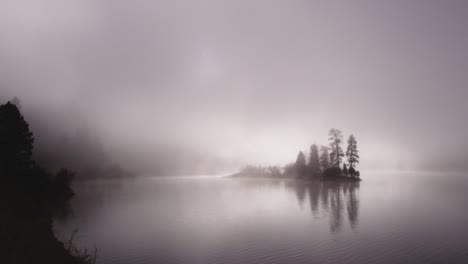 foggy dramatic scene looking across swan lake in montana