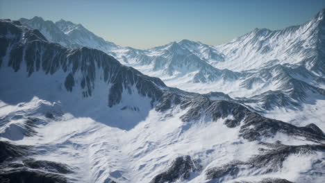 aerial view from airplane of blue snow covered canadian mountain landscape