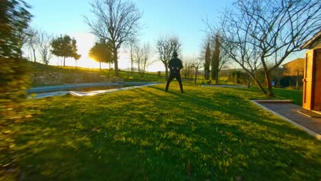 golden hour outdoors: fpv drone pilot in a serene landscape with sunset glow