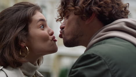 cheerful couple grimacing on street. man and woman fooling on city background.