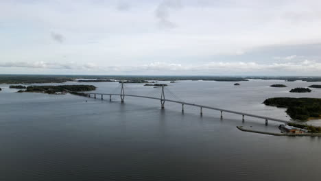 Aerial-wide-view-of-Replot-Bridge,-a-suspended-bridge-in-Finland,-Slowly-Orbiting-shot