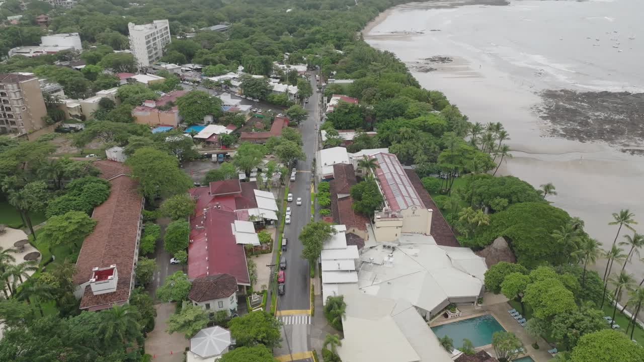 Downtown in Tamarindo, Guanacaste Province in Costa Rica with drone moving pulling back and moving up