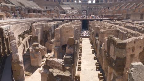 panning shot tourists walking along colosseum interior impressive