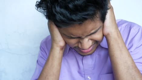 stressed man covering ears