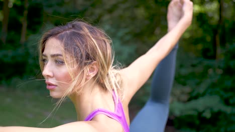 close up of woman doing yoga in a park