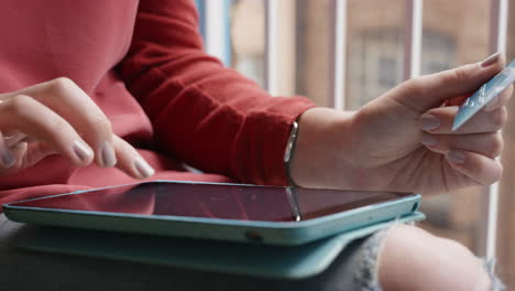 woman shopping with credit card using digital tablet at home