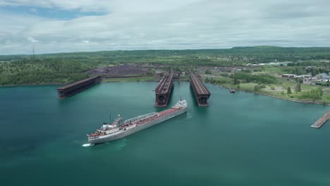 Aerial,-michipicoten-lake-freighter-cargo-vessel-ship-docking-at-Agate-Bay-Two-Harbors-in-Minnesota