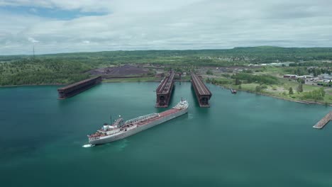 aerial, michipicoten lake freighter cargo vessel ship docking at agate bay two harbors in minnesota