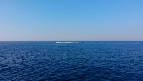 blue sea and bright sky beautiful panorama with boat sailing in horizon line, summer vacation