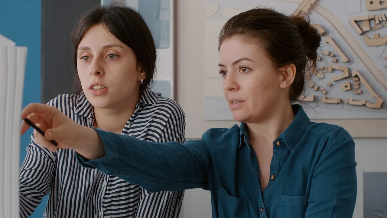 Two women working on architectural designs