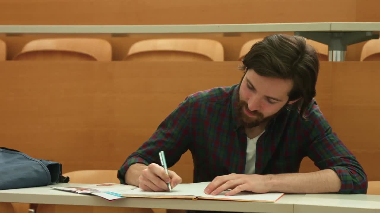 Focused student taking down notes