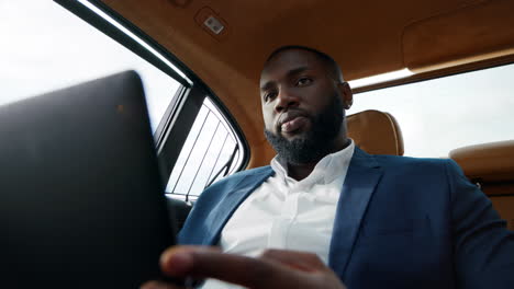 Closeup-african-man-talking-video-call-at-car.-Man-talking-to-driver-at-vehicle