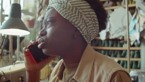 African-American-Woman-Talking-on-Phone-in-Workshop